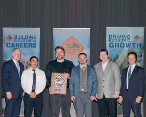 From Left: Grant Main, Deputy Minister, Vincent Sylvester, Kevin Breti, Robert Esau, David Crilly (all with Total Build) and Kevin Richter, Assistant Deputy Minister